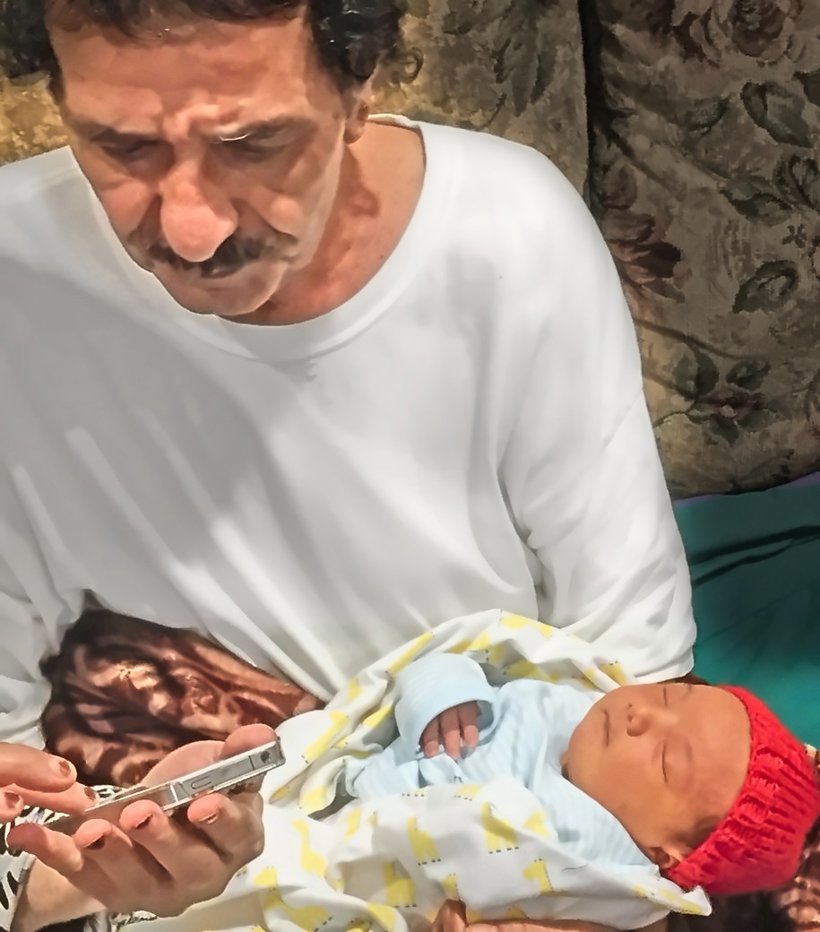 Joe holding a newborn